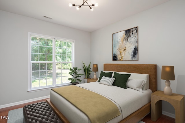 2021 Patapsco Dr, Apex, NC 27523 - bedroom featuring multiple windows, wood finished floors, and a chandelier