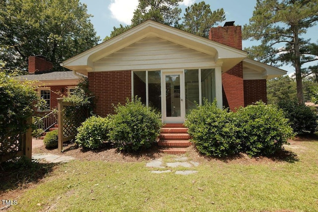 1801 Bethlehem Rd, Rocky Mount, NC 27803 - back of property with a chimney, entry steps, a yard, and brick siding