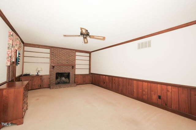 1801 Bethlehem Rd, Rocky Mount, NC 27803 - unfurnished living room with a ceiling fan, a wainscoted wall, light carpet, wood walls, and a brick fireplace