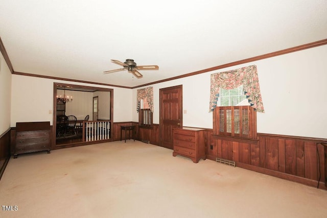 1801 Bethlehem Rd, Rocky Mount, NC 27803 - carpeted empty room with wainscoting, a ceiling fan, crown molding, a chandelier, and wooden walls