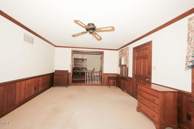 1801 Bethlehem Rd, Rocky Mount, NC 27803 - spare room with wainscoting, wood walls, a ceiling fan, light colored carpet, and crown molding