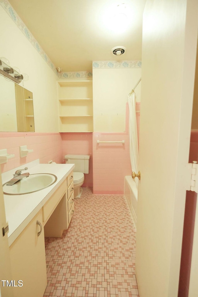 1801 Bethlehem Rd, Rocky Mount, NC 27803 - full bath with tile walls, tile patterned floors, vanity, wainscoting, and shower / bath combination with curtain