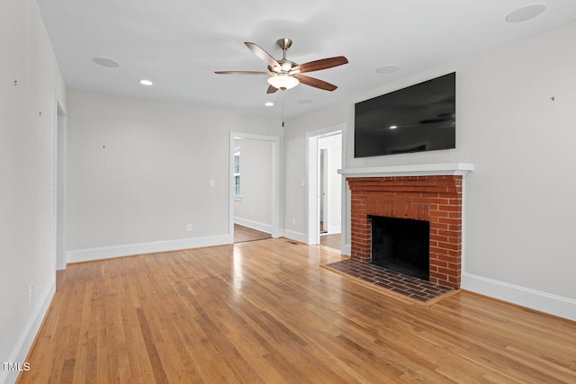 216 Whitfield St, Enfield, NC 27823 - unfurnished living room featuring a ceiling fan, light wood-type flooring, a fireplace, and recessed lighting