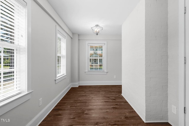 216 Whitfield St, Enfield, NC 27823 - empty room featuring dark wood-style flooring and a chandelier