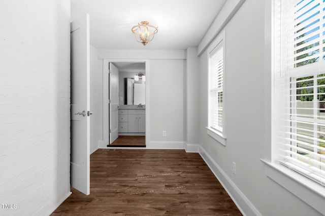 216 Whitfield St, Enfield, NC 27823 - hall with a chandelier and dark wood-style floors