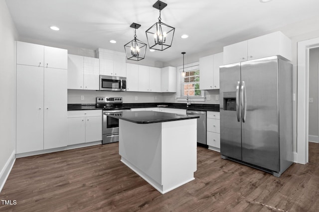216 Whitfield St, Enfield, NC 27823 - kitchen with stainless steel appliances, a chandelier, dark countertops, a center island, and recessed lighting