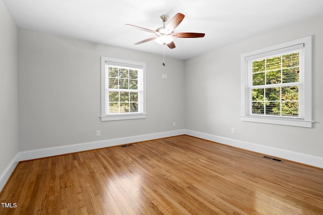 216 Whitfield St, Enfield, NC 27823 - unfurnished room with healthy amount of natural light, light wood-style flooring, and a ceiling fan