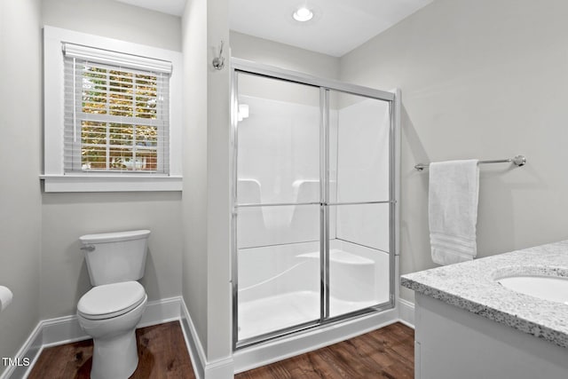 216 Whitfield St, Enfield, NC 27823 - full bath with a stall shower, wood finished floors, and vanity