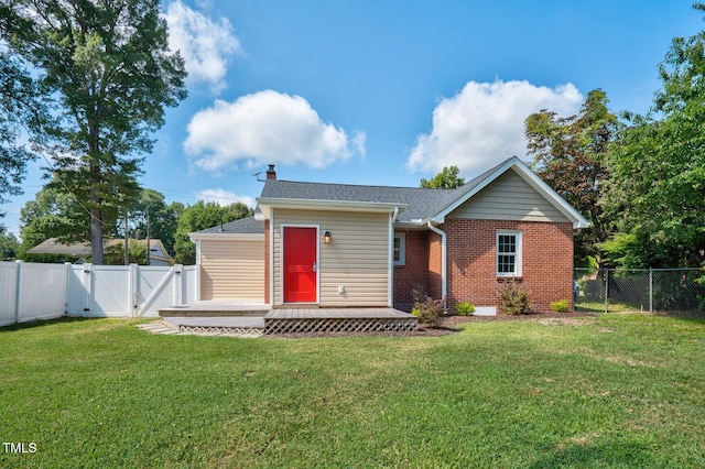 216 Whitfield St, Enfield, NC 27823 - view of front of property featuring a gate, a fenced backyard, a deck, a chimney, and brick siding