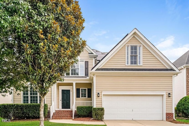 5933 Big Nance Dr, Raleigh, NC 27616 - traditional-style house with driveway, a garage, and covered porch