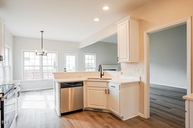 5933 Big Nance Dr, Raleigh, NC 27616 - kitchen featuring stainless steel appliances, light wood-type flooring, a chandelier, light countertops, and recessed lighting
