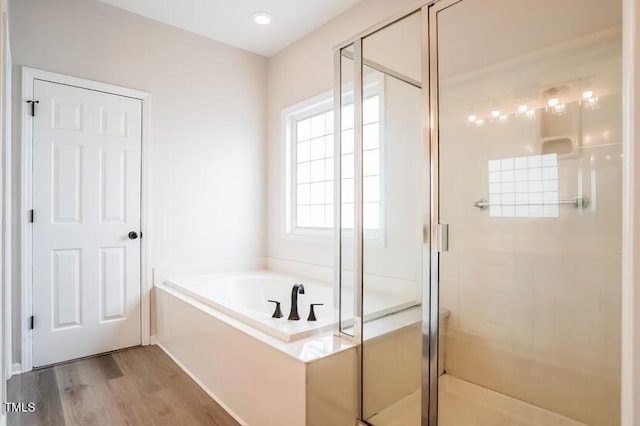 5933 Big Nance Dr, Raleigh, NC 27616 - bathroom featuring a bath, a shower stall, and wood finished floors