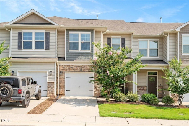 1119 Latitude Dr, Durham, NC 27713 - multi unit property featuring concrete driveway, an attached garage, and stone siding