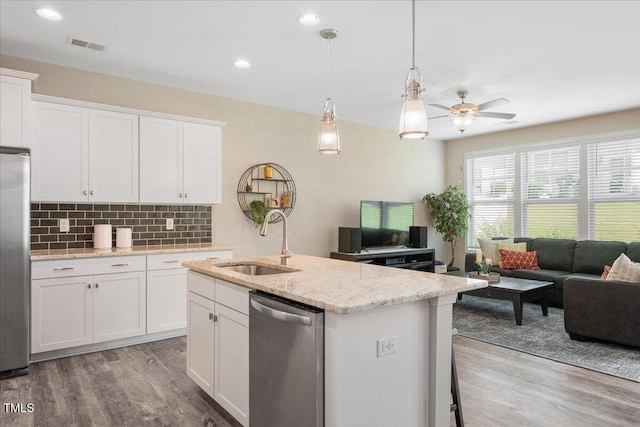 1119 Latitude Dr, Durham, NC 27713 - kitchen with stainless steel appliances, light wood-type flooring, open floor plan, decorative backsplash, and a ceiling fan