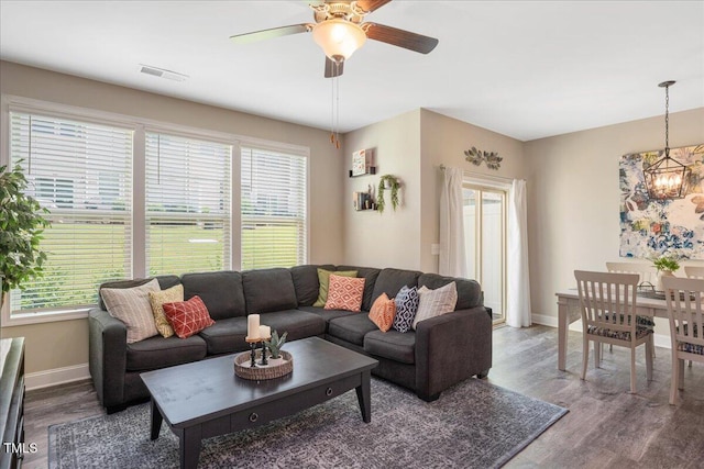 1119 Latitude Dr, Durham, NC 27713 - living room with plenty of natural light, wood finished floors, a chandelier, and a ceiling fan