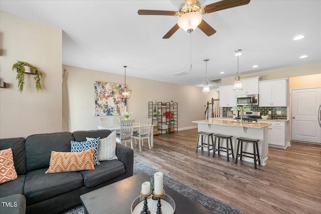 1119 Latitude Dr, Durham, NC 27713 - living room featuring dark wood-style flooring, recessed lighting, and a ceiling fan