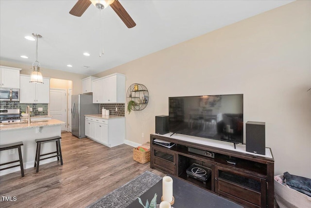 1119 Latitude Dr, Durham, NC 27713 - living area with recessed lighting, light wood finished floors, and ceiling fan