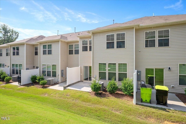1119 Latitude Dr, Durham, NC 27713 - back of property with a patio area and a lawn