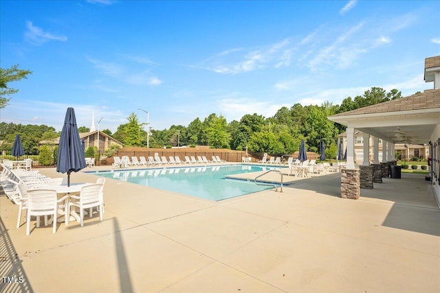 1119 Latitude Dr, Durham, NC 27713 - community pool featuring a patio area, view of wooded area, and ceiling fan