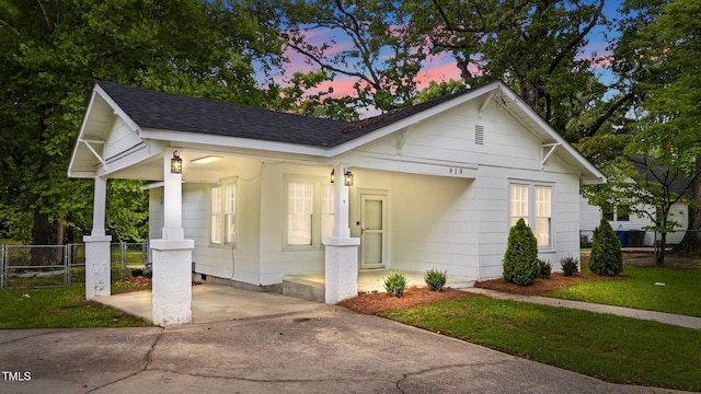 919 College Cir N, Wilson, NC 27893 - bungalow-style home featuring roof with shingles, concrete driveway, and a gate