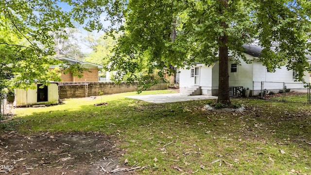 919 College Cir N, Wilson, NC 27893 - fenced backyard with a storage unit, a patio area, and entry steps