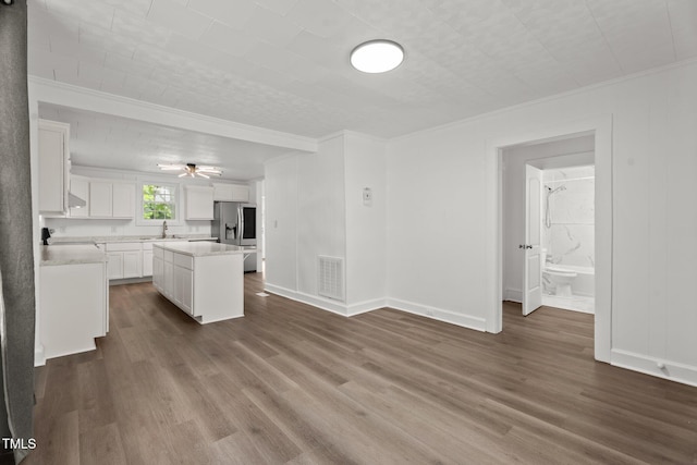 919 College Cir N, Wilson, NC 27893 - kitchen featuring ornamental molding, stainless steel refrigerator with ice dispenser, light countertops, white cabinetry, and dark wood-style floors