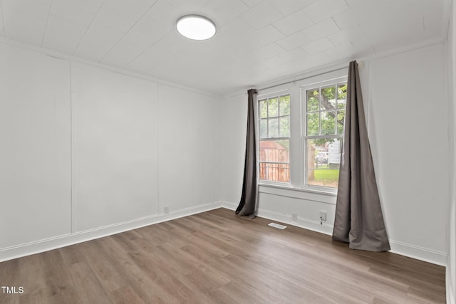 919 College Cir N, Wilson, NC 27893 - unfurnished room with crown molding, healthy amount of natural light, wood finished floors, and a decorative wall
