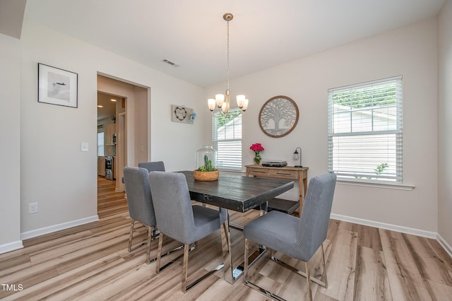 3922 Cross Timber Ln, Raleigh, NC 27603 - dining room featuring a chandelier and light wood finished floors