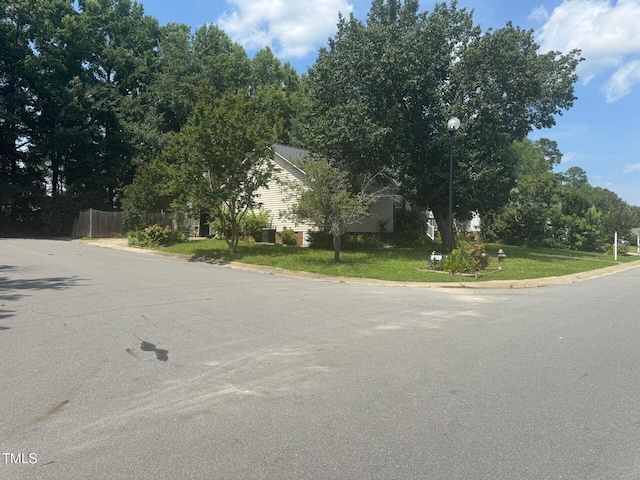 165 Cambridge Elm Dr, Clayton, NC 27520 - view of asphalt road featuring street lights and curbs