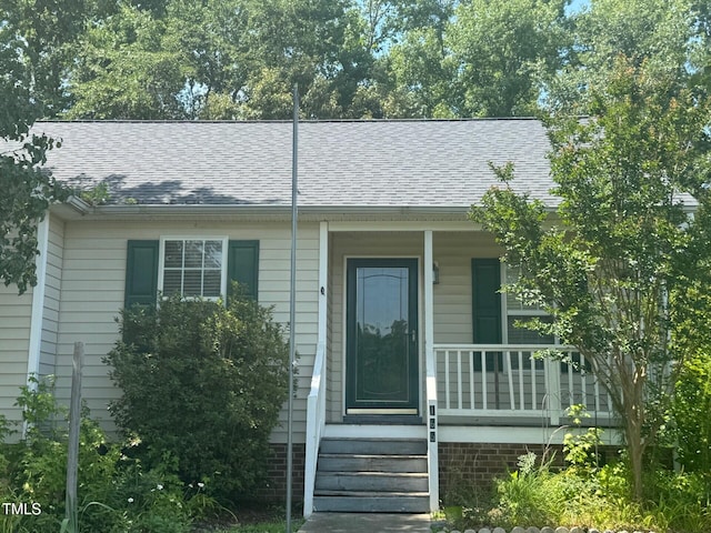 165 Cambridge Elm Dr, Clayton, NC 27520 - view of front facade featuring covered porch and a shingled roof