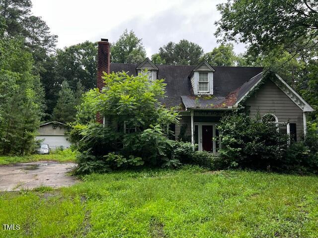 3573 River View Cir, Oxford, NC 27565 - cape cod-style house with a chimney and a front yard