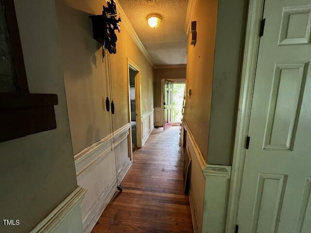 3573 River View Cir, Oxford, NC 27565 - corridor featuring ornamental molding, a decorative wall, wood finished floors, a textured ceiling, and a wainscoted wall