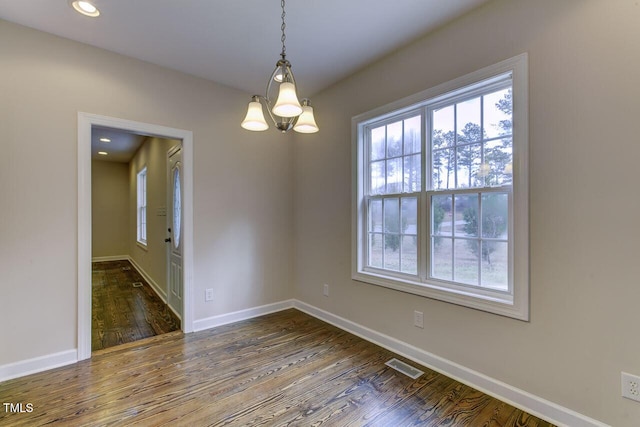 619 Rudy Dr, Clayton, NC 27520 - unfurnished room with plenty of natural light, a chandelier, wood finished floors, and recessed lighting