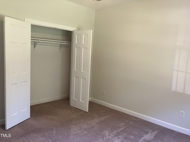 619 Rudy Dr, Clayton, NC 27520 - unfurnished bedroom with dark carpet and a closet
