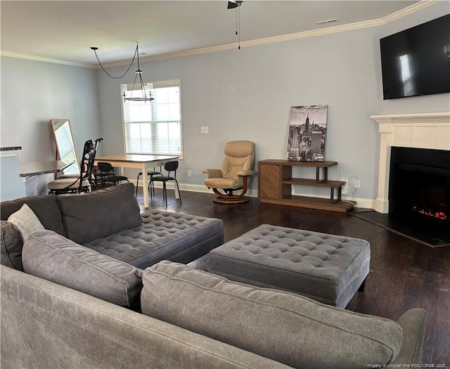 914 W Rowan St SW, Fayetteville, NC 28301 - living area featuring wood finished floors, ornamental molding, and a fireplace with raised hearth