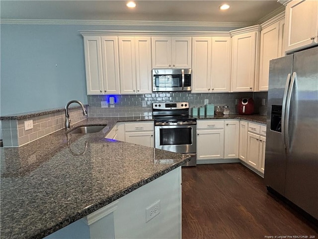 914 W Rowan St SW, Fayetteville, NC 28301 - kitchen featuring stainless steel appliances, a peninsula, ornamental molding, backsplash, and dark stone counters