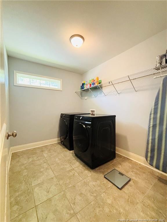 914 W Rowan St SW, Fayetteville, NC 28301 - washroom with washing machine and clothes dryer and baseboards