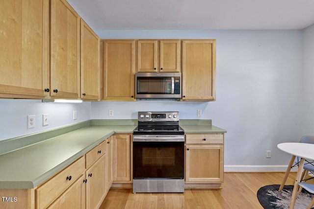 203 Bluefield Rd, Chapel Hill, NC 27517 - kitchen with appliances with stainless steel finishes, light brown cabinets, light wood finished floors, and light countertops