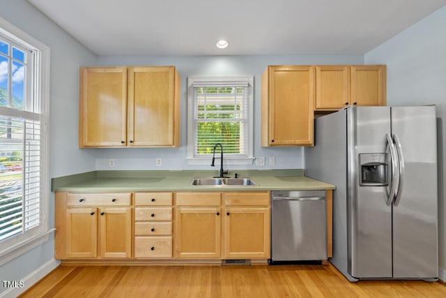 203 Bluefield Rd, Chapel Hill, NC 27517 - kitchen with stainless steel appliances, light brown cabinetry, light wood finished floors, light countertops, and recessed lighting