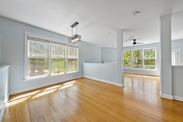 203 Bluefield Rd, Chapel Hill, NC 27517 - unfurnished room featuring ceiling fan, wood finished floors, a smoke detector, a chandelier, and ornate columns