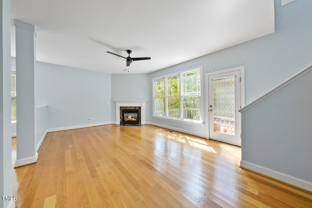 203 Bluefield Rd, Chapel Hill, NC 27517 - unfurnished living room with ceiling fan, light wood-style floors, and a fireplace