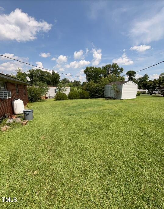 2035 Simpkins Rd, Raleigh, NC 27603 - view of green lawn with a storage unit
