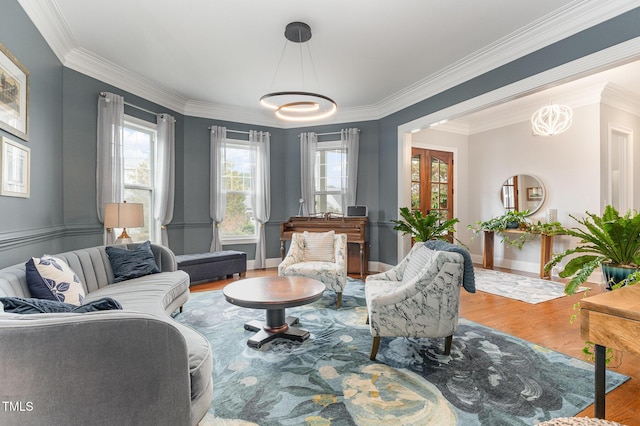 1501 Heritage Reserve Ct, Wake Forest, NC 27587 - living room with ornamental molding, wood finished floors, plenty of natural light, and a chandelier