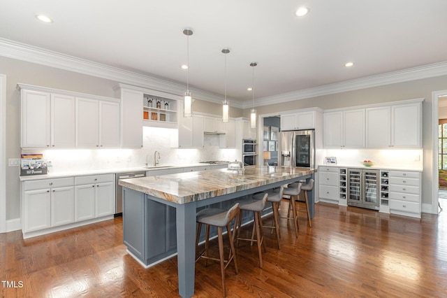 1501 Heritage Reserve Ct, Wake Forest, NC 27587 - kitchen with stainless steel appliances, beverage cooler, white cabinets, ornamental molding, and recessed lighting