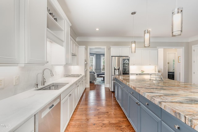 1501 Heritage Reserve Ct, Wake Forest, NC 27587 - kitchen featuring appliances with stainless steel finishes, white cabinets, hanging light fixtures, ornamental molding, and light wood-style flooring