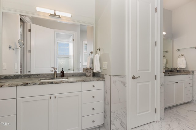 1501 Heritage Reserve Ct, Wake Forest, NC 27587 - full bathroom featuring marble look tiles, two vanities, and wainscoting