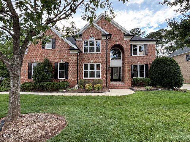 10733 Round Brook Cir, Raleigh, NC 27617 - view of front facade featuring brick siding and a front yard