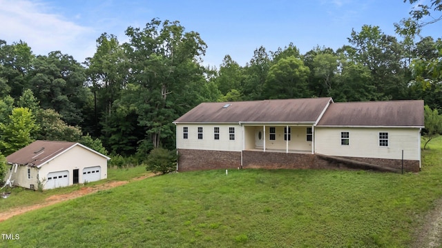 129 Shaman Dr, Louisburg, NC 27549 - view of front facade with a front lawn, a detached garage, an outbuilding, and a porch