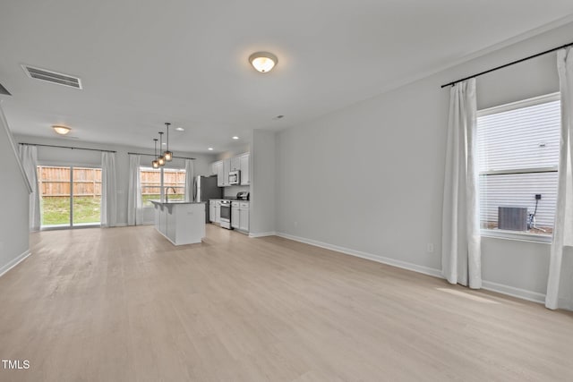 5404 Rutledgeville Ln, Knightdale, NC 27545 - unfurnished living room with light wood-style floors and recessed lighting