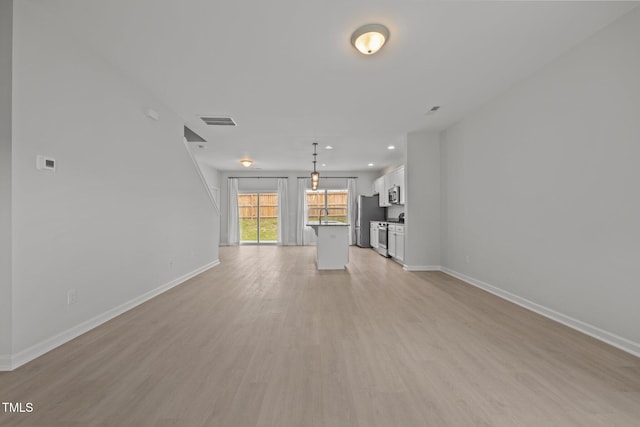 5404 Rutledgeville Ln, Knightdale, NC 27545 - unfurnished living room featuring light wood-style floors and recessed lighting